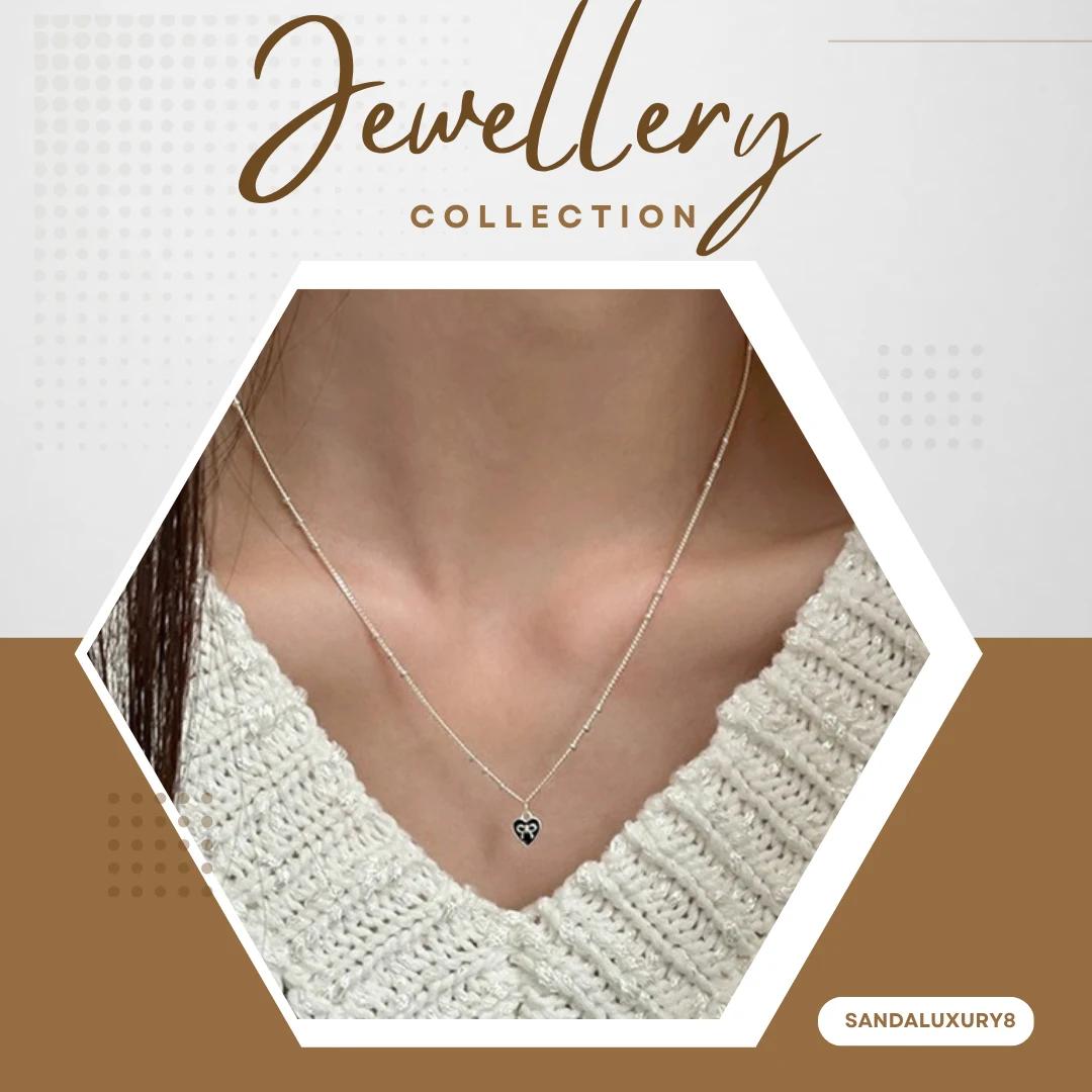 Silver chain necklace with black heart pendant